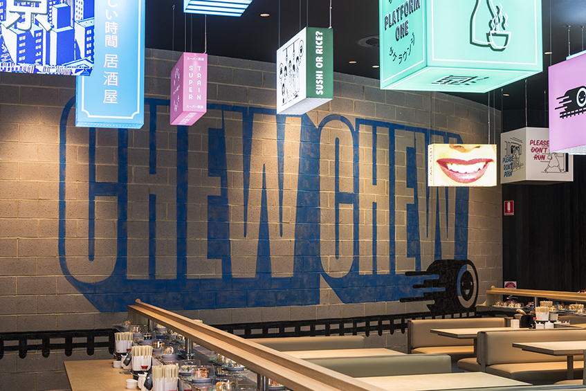 A restaurant facade with a large, eye-catching sign that reads "Chewy" prominently displayed.