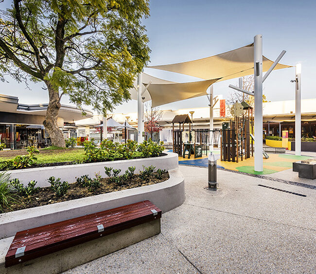A serene city park with benches nestled among trees, inviting visitors to enjoy nature and tranquility.