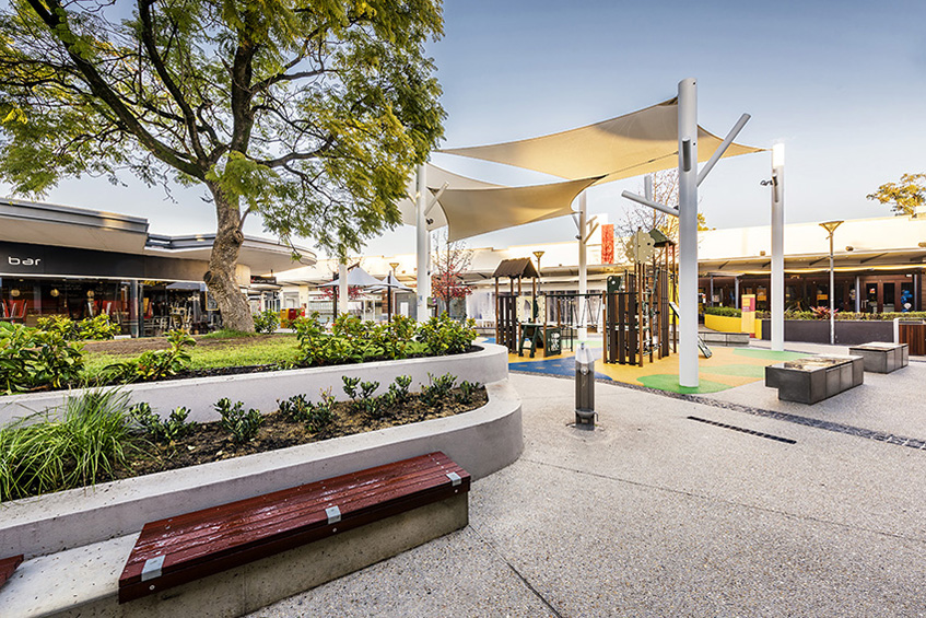 A serene city park with benches nestled among trees, inviting visitors to enjoy nature and tranquility.